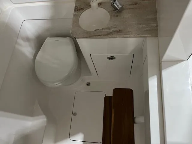 Slide: The Image of 2022 Valhalla V 37 boat bathroom with toilet, sink, and wooden accents. - 33