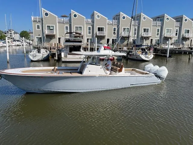 Slide: The Image of 2022 Valhalla Boatworks V-37 in marina, modern townhouses in background. - 4