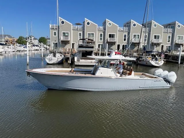 Slide: The Image of 2022 Valhalla Boatworks V-37 in marina, modern townhouses in background. - 5