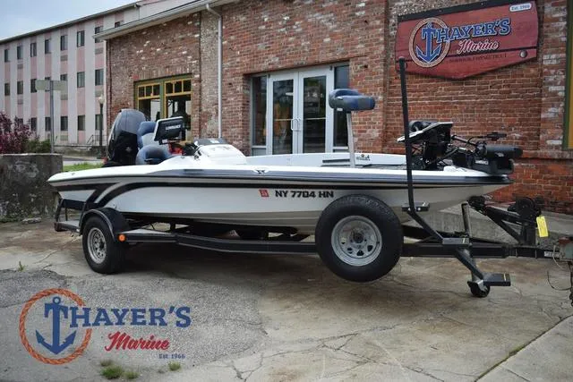 Slide: The Image of 1997 Pro Craft 180 boat on trailer at Thayer's Marine, brick building background. - 1