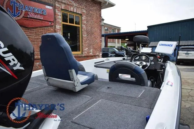 Slide: The Image of 1997 Pro Craft 180 boat with Mercury engine, featuring seating and navigation equipment, at Thayer's Marine. - 11