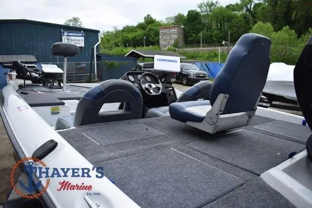 Slide: The Image of 1997 Pro Craft 180 boat with blue seats and fishing equipment, displayed at Thayer's Marine. - 12