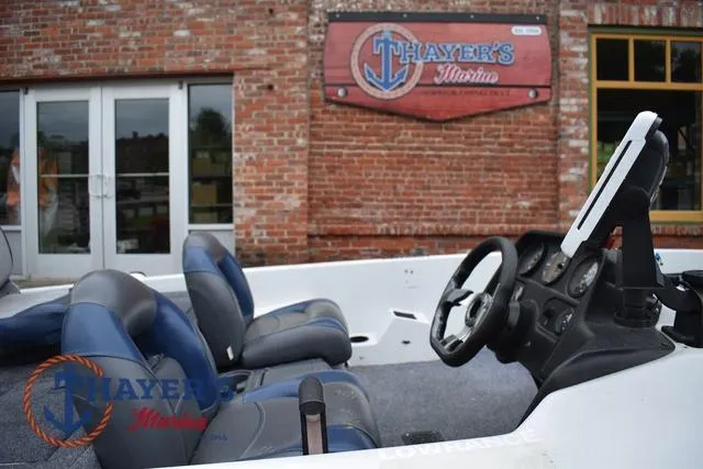 Slide: The Image of 1997 Pro Craft 180 boat interior with blue seats, steering wheel, and dashboard at Thayer's Marine. - 13