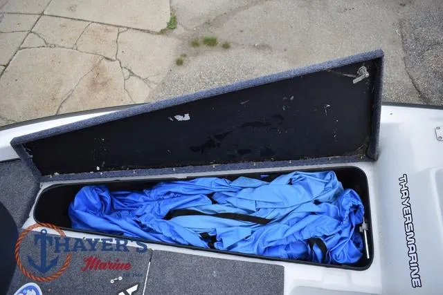 Slide: The Image of Open storage compartment in a 1997 Pro Craft 180 boat with blue cover inside. - 22