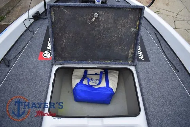 Slide: The Image of Open storage compartment on 1997 Pro Craft 180 boat with blue and white bag inside. - 23