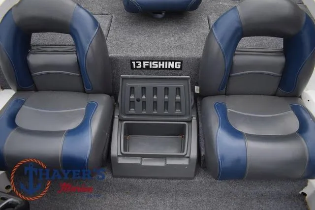 Slide: The Image of Two blue and gray boat seats with a central storage compartment. - 26