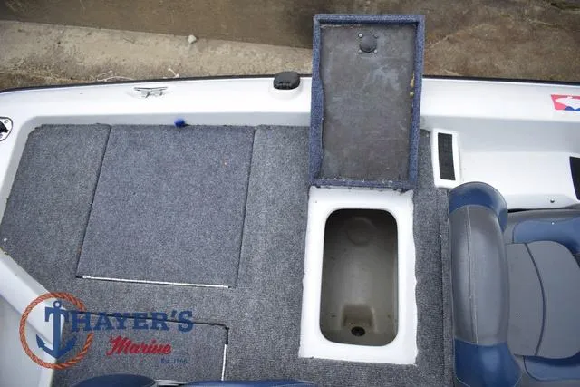 Slide: The Image of 1997 Pro Craft 180 boat interior with open storage compartment and carpeted deck. - 28