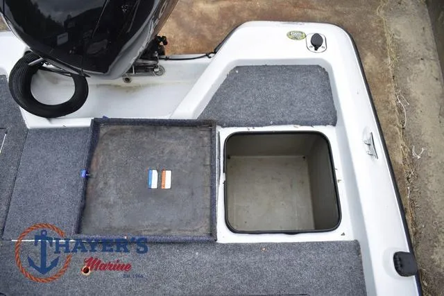 Slide: The Image of 1997 Pro Craft 180 boat storage compartment with open hatch, featuring Thayer's Marine logo. - 29