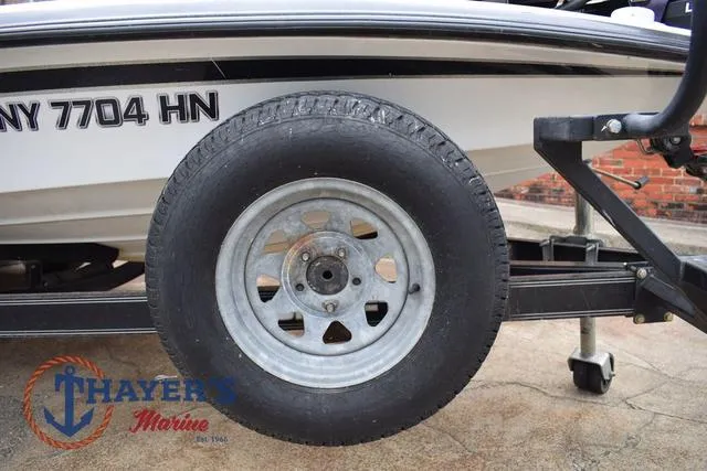 Slide: The Image of Trailer wheel of a 1997 Pro Craft 180 boat, featuring Thayer's Marine logo. - 41