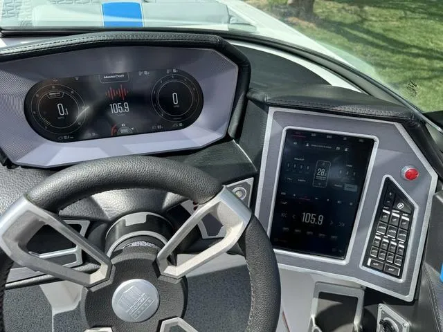 Slide: The Image of Dashboard of a 2022 MasterCraft X24 boat with digital displays and steering wheel. - 18