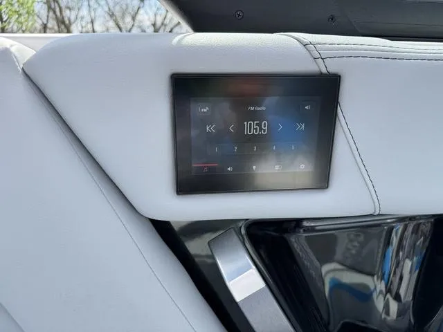 Slide: The Image of 2022 MasterCraft X24 boat interior with digital radio display showing FM 105.9. - 20