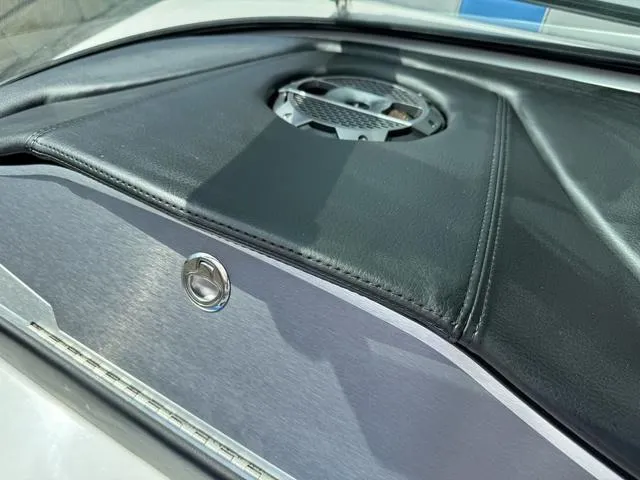 Slide: The Image of 2022 MasterCraft X24 boat interior with sleek black leather and speaker detail. - 21