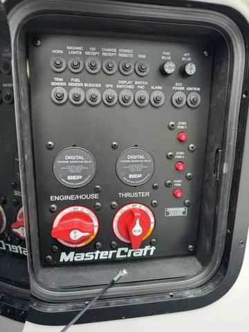 Slide: The Image of Control panel of a 2022 MasterCraft X24 boat with various switches and dials. - 22
