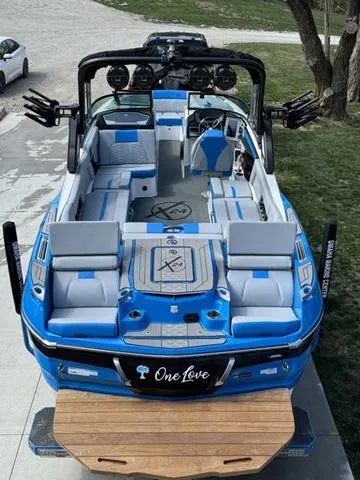 Slide: The Image of 2022 MasterCraft X24 boat with blue and white interior, featuring a sleek design and spacious seating. - 4