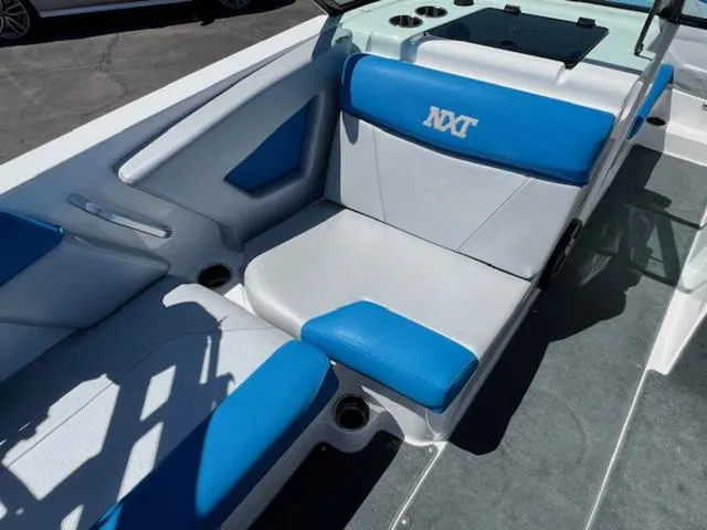 Slide: The Image of 2018 MasterCraft NXT22 boat interior with blue and white seating. - 12