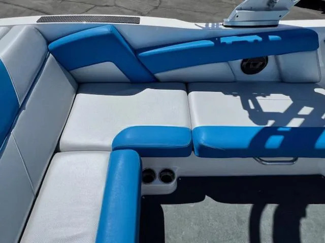 Slide: The Image of 2018 MasterCraft NXT22 boat interior with blue and white seating. - 13