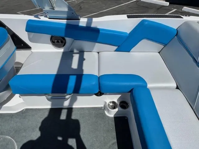 Slide: The Image of 2018 MasterCraft NXT22 boat interior with blue and white seating. - 15