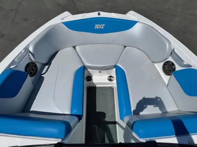 Slide: The Image of 2018 MasterCraft NXT22 boat interior with blue and white seating. - 16