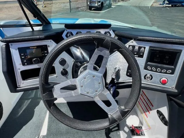 Slide: The Image of Steering wheel and dashboard of a 2018 MasterCraft NXT22 boat. - 19