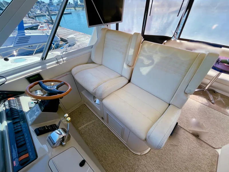 Slide: The Image of Interior of 2005 Sea Ray Motor Yacht with plush seating and helm station. - 10