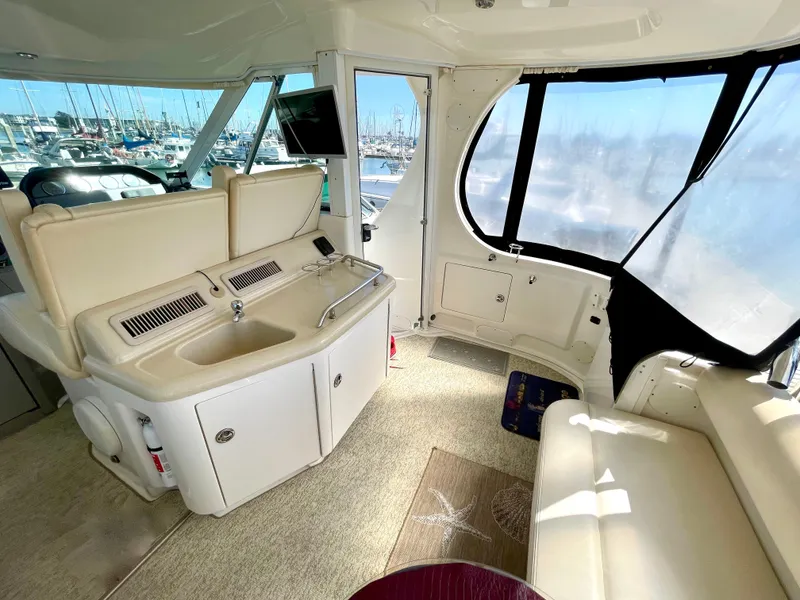 Slide: The Image of Interior of 2005 Sea Ray Motor Yacht with seating, sink, and marina view. - 13