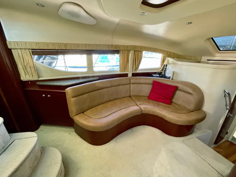 Slide: The Image of Luxurious 2005 Sea Ray Motor Yacht interior with curved leather seating and a red cushion. - 17