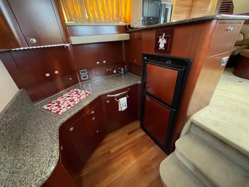 Slide: The Image of Luxurious 2005 Sea Ray Motor Yacht kitchen with wood cabinetry and granite countertops. - 18