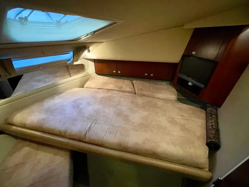 Slide: The Image of 2005 Sea Ray Motor Yacht cabin with bed, skylight, and wooden cabinetry. - 21