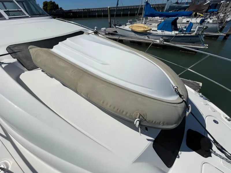 Slide: The Image of 2005 Sea Ray Motor Yacht with inflatable dinghy on deck, docked at marina. - 41