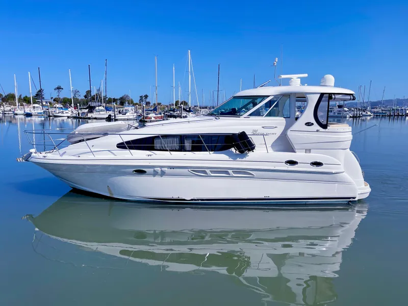Slide: The Image of 2005 Sea Ray Motor Yacht docked in a marina, reflecting on calm water. - 42