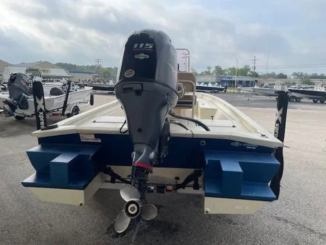Slide: The Image of 2019 Xpress SW20B boat with 115 horsepower outboard motor, parked in a marina. - 10