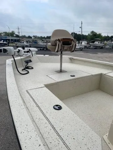 Slide: The Image of 2019 Xpress SW20B boat with seating and motor, parked in a marina. - 4