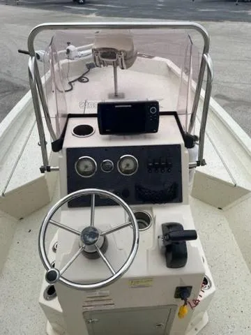 Slide: The Image of 2019 Xpress SW20B boat console with steering wheel, controls, and navigation system. - 7