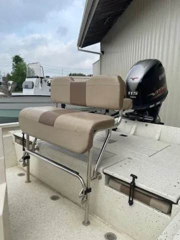Slide: The Image of 2019 Xpress SW20B boat with Yamaha 115 VMAX engine, featuring beige seating and a spacious deck. - 9