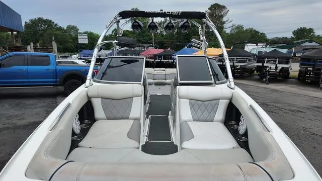 Slide: The Image of 2011 MasterCraft X45 boat interior with seating and speakers, parked outdoors. - 10