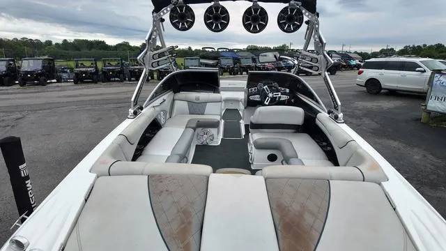Slide: The Image of 2011 MasterCraft X45 boat interior with seating and speakers, parked outdoors. - 11
