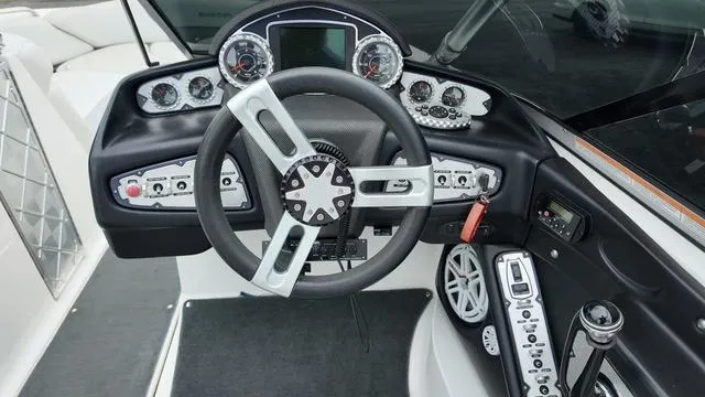 Slide: The Image of Steering wheel and dashboard of a 2011 MasterCraft X45 boat, featuring modern controls and gauges. - 17