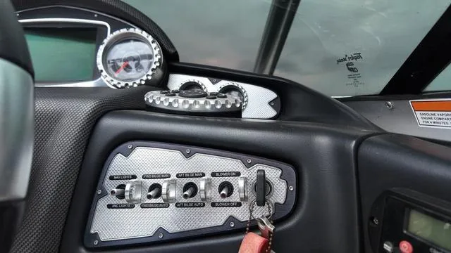 Slide: The Image of Dashboard of a 2011 MasterCraft X45 boat with control switches and gauges. - 19