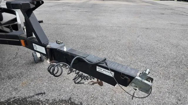 Slide: The Image of Trailer hitch of a 2011 MasterCraft X45 boat on asphalt surface. - 9