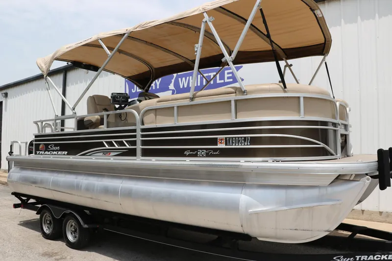 Slide: The Image of 2020 Sun Tracker SportFish 22 XP3 pontoon boat with canopy on trailer. - 11