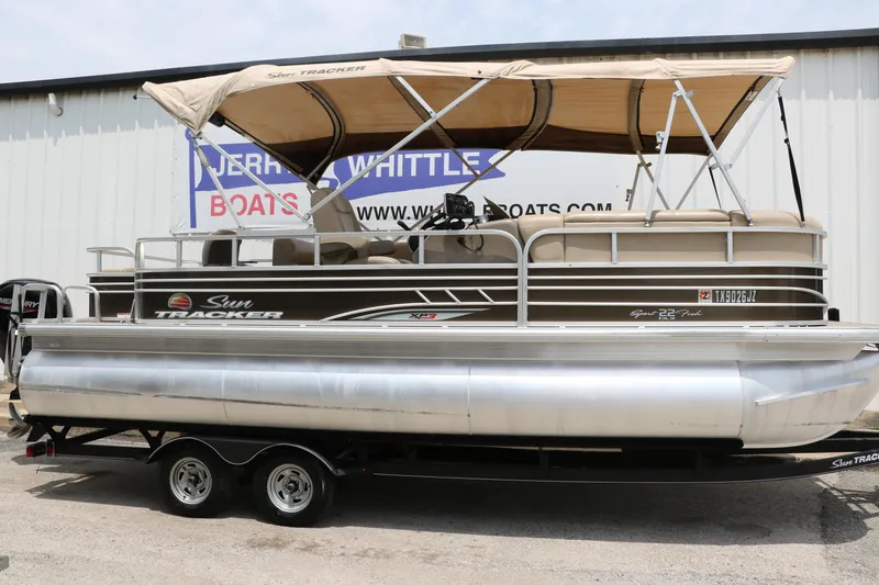 Slide: The Image of 2020 Sun Tracker SportFish 22 XP3 pontoon boat with canopy, parked on a trailer. - 13