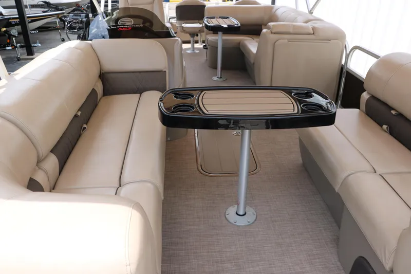 Slide: The Image of 2020 Sun Tracker SportFish 22 XP3 interior with beige seating and table. - 14