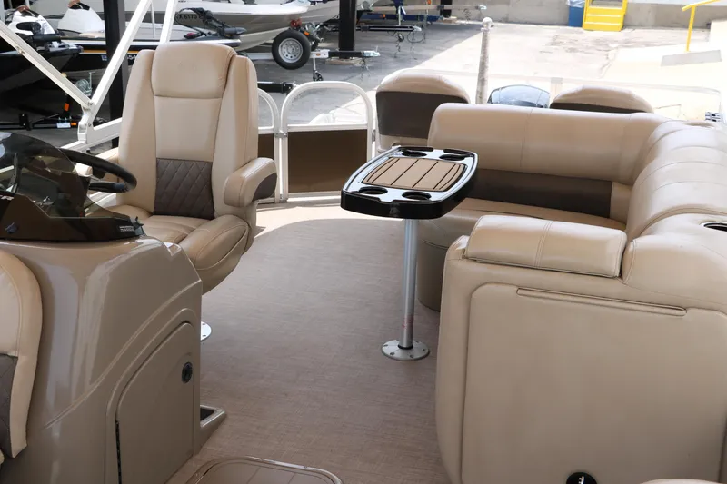 Slide: The Image of 2020 Sun Tracker SportFish 22 XP3 interior with beige seating and table. - 16