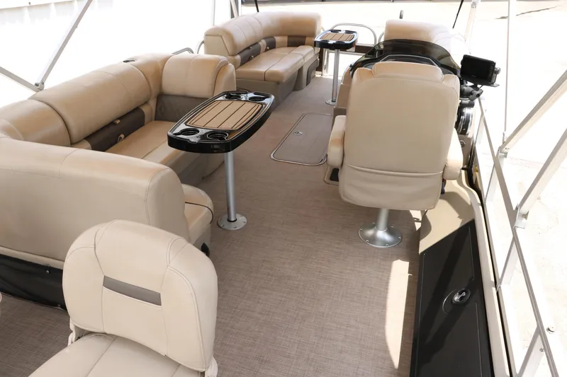 Slide: The Image of 2020 Sun Tracker SportFish 22 XP3 interior with beige seating and tables. - 19