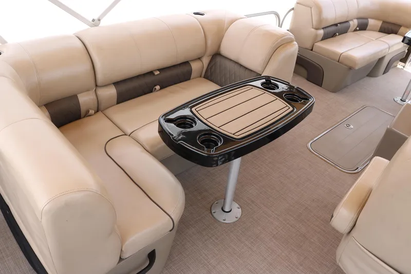 Slide: The Image of 2020 Sun Tracker SportFish 22 XP3 interior with beige seating and a central table. - 21