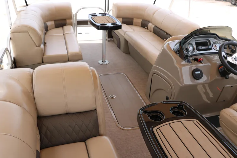 Slide: The Image of 2020 Sun Tracker SportFish 22 XP3 interior with beige seating and modern dashboard. - 22