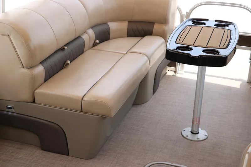 Slide: The Image of 2020 Sun Tracker SportFish 22 XP3 interior with beige seating and table. - 24