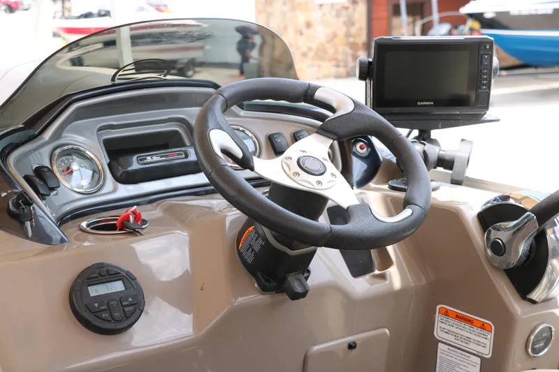 Slide: The Image of 2020 Sun Tracker SportFish 22 XP3 dashboard with steering wheel and navigation system. - 26