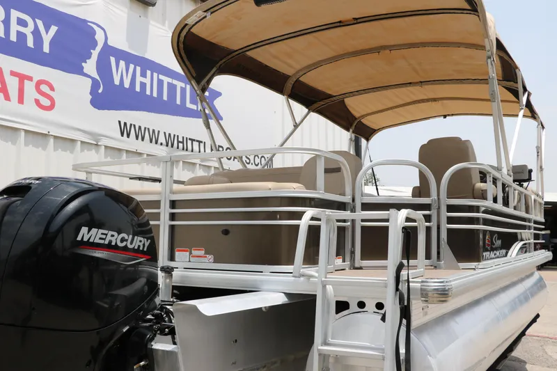 Slide: The Image of 2020 Sun Tracker SportFish 22 XP3 pontoon boat with Mercury engine, docked near Whittle Boats sign. - 3