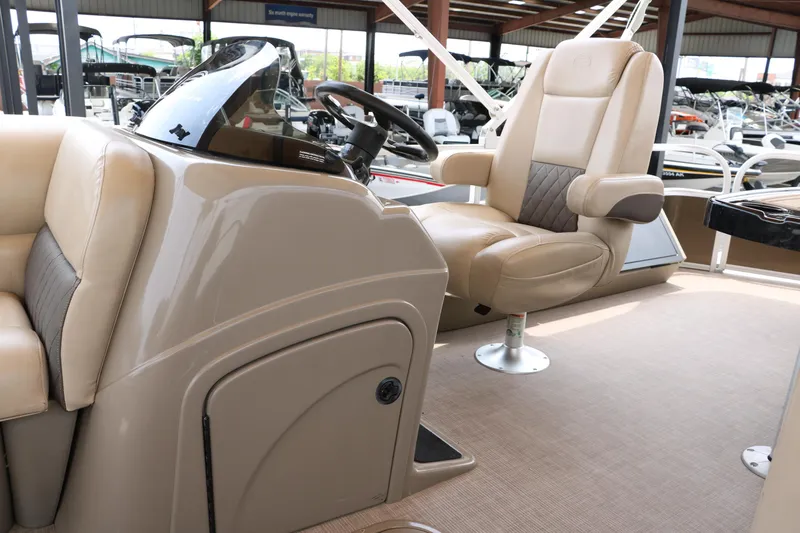 Slide: The Image of 2020 Sun Tracker SportFish 22 XP3 boat interior with beige captain's chair and console. - 32